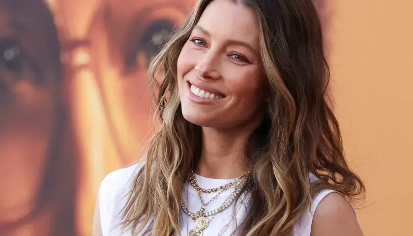 Jessica Biel sonríe con su pelo liso y mechas balayage, luciendo collares dorados.