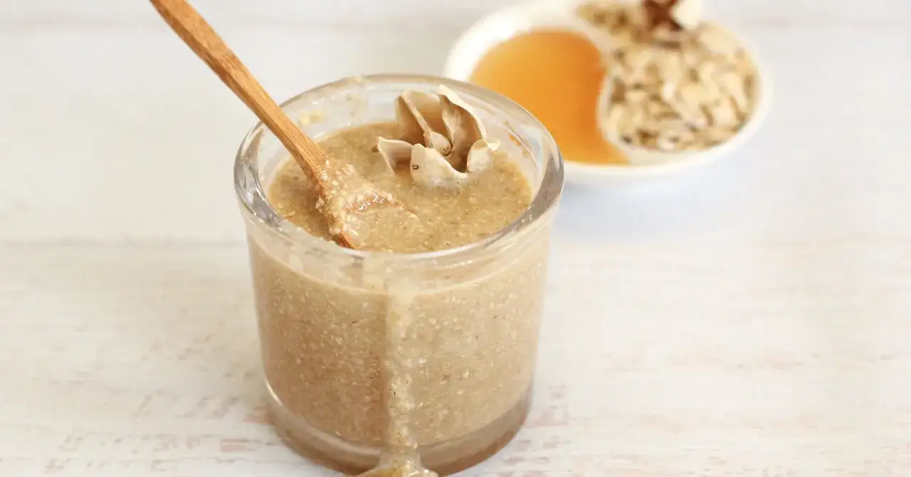 Un tarro de exfoliante facial casero con avena y miel, listo para una piel radiante.